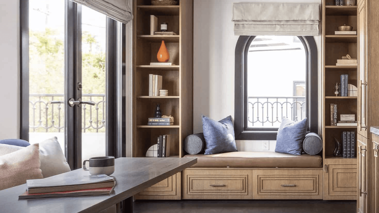 A vibrant dog park bathed in sunlight features abundant greenery with mature trees, offering ample shade for leisurely outdoor activities. In the distance is a well-equipped playground that presents an additional activity area. An inviting picnic table spreads out nearby, ideal for enjoying meals al fresco or taking relaxing breaks from play. A neatly-placed trash bin aids in maintaining the park's cleanliness for everyone's enjoyment. Dominating the scene is a generously wide dirt path gracefully curving through the expanse of grass, promising exploratory walks and lively fetch games.